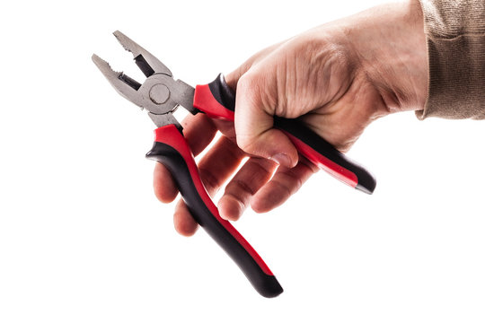 holding red pliers on white