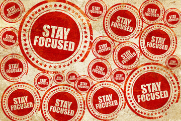 Obraz premium stay focused, red stamp on a grunge paper texture