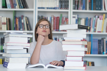 female student study in library, using tablet and searching for