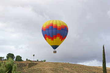 Fototapeta na wymiar Balloon launch over hill during spring morning