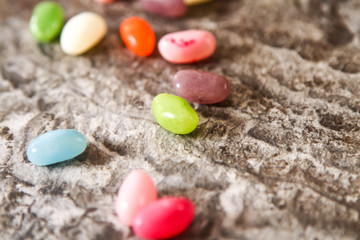 Colorful Jelly Beans on background stone