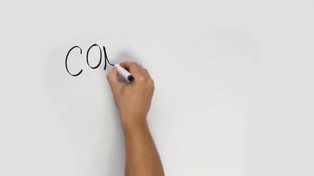 Hand using a black marker to write an intro title CONCEPT on a whiteboard