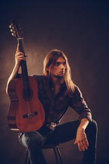 Fototapeta na wymiar Young man holding guitar.