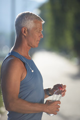 senior jogging man drinking fresh water from bottle