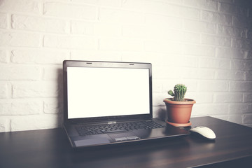 computer on table on Brick wall