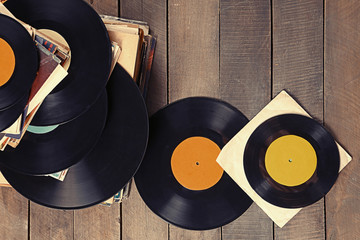 Pile of old vinyl records on wooden background