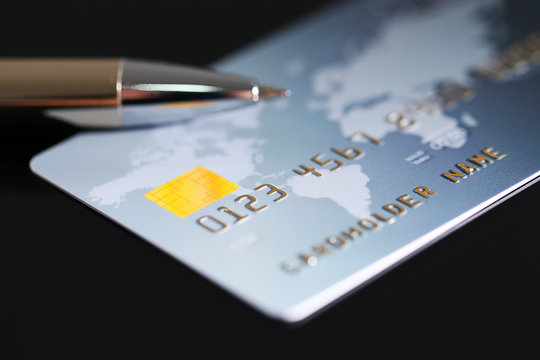 Credit card with pen, close up