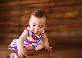 Cute little girl on a wooden background.