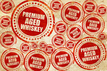 premium aged whiskey, red stamp on a grunge paper texture