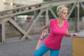 blonde woman  stretching before morning jogging