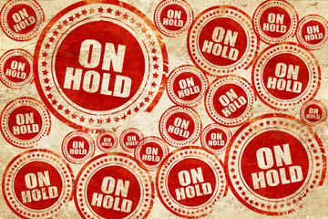 Obraz premium on hold, red stamp on a grunge paper texture