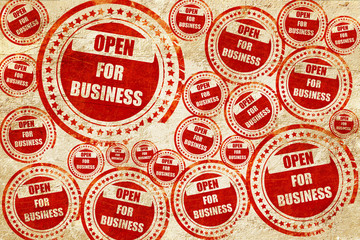 Open for business sign, red stamp on a grunge paper texture