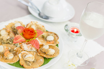 Baked scallops with butter and soy sauce in natural scallop shell delicious Thai seafood.