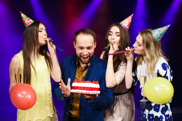 Happy birthday! Group of smiling friends gathered together with