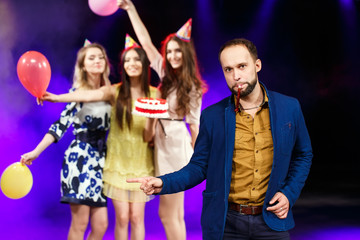 Happy birthday! Group of smiling friends gathered together with