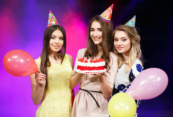 Happy birthday! Group of smiling friends gathered together with