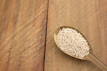 Quinoa grains on wooden background