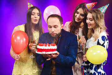 Happy birthday! Group of smiling friends gathered together with