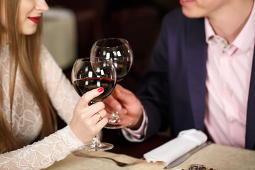 Couple toasting wineglasses in a luxury restaurant.