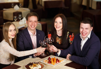 Friends at a restaurant drinking wine.