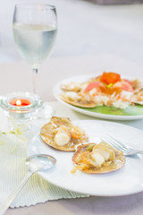 Baked scallops with butter and soy sauce in natural scallop shell delicious Thai seafood.