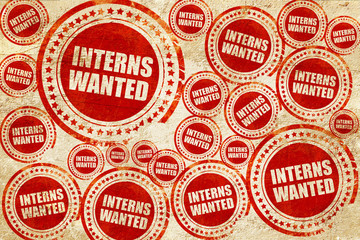 interns wanted, red stamp on a grunge paper texture