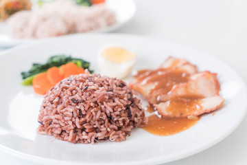 Barbecued red pork in sauce with berry rice