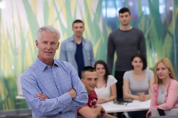 portrait of  teacher with students group in background