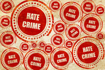 Obraz premium Hate crime background, red stamp on a grunge paper texture