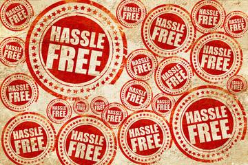 hassle free, red stamp on a grunge paper texture