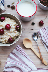 rich breakfast of porridge with cherries and pastry