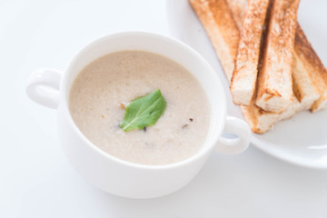 mushroom soup and bread in white ceramic cup