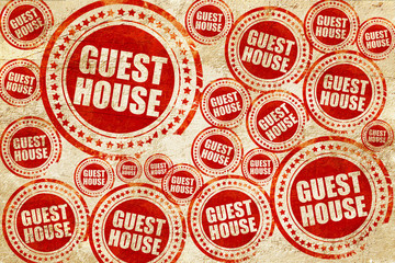 Obraz premium guesthouse, red stamp on a grunge paper texture