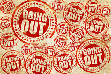 going out, red stamp on a grunge paper texture