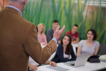 teacher with a group of students in classroom