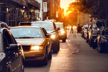 Car traffic on New York City street at sunset time