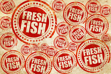 fresh fish, red stamp on a grunge paper texture