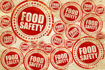 food safety, red stamp on a grunge paper texture