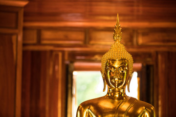 The Most Beautiful Golden Buddha ; Gold face Buddha statue at public worship, Thailand
