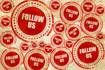 follow us, red stamp on a grunge paper texture