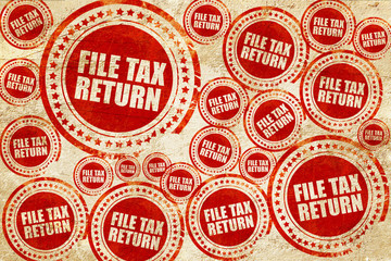 file tax return, red stamp on a grunge paper texture