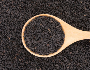 Black Sesame seeds in wood spoon background