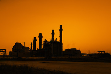 Fototapeta na wymiar Gas turbine electrical power plant at dusk