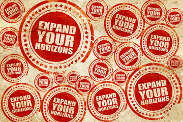 Obraz premium expand your horizons, red stamp on a grunge paper texture