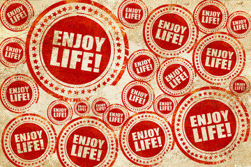 enjoy life!, red stamp on a grunge paper texture