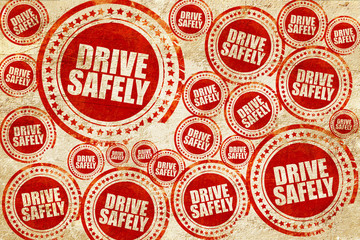 drive safely, red stamp on a grunge paper texture