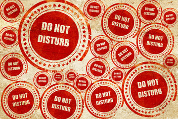 Do not disturb sign, red stamp on a grunge paper texture