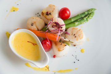 gourmet seared scallops with garnishes.