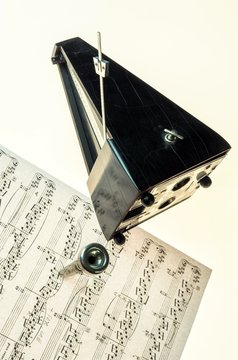 Metronome and mouthpiece of a trumpet isolated on a blank white