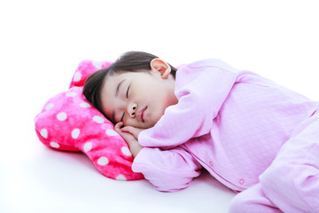 Obraz na płótnie Canvas Healthy children concept. Asian girl sleeping peacefully. On white background.